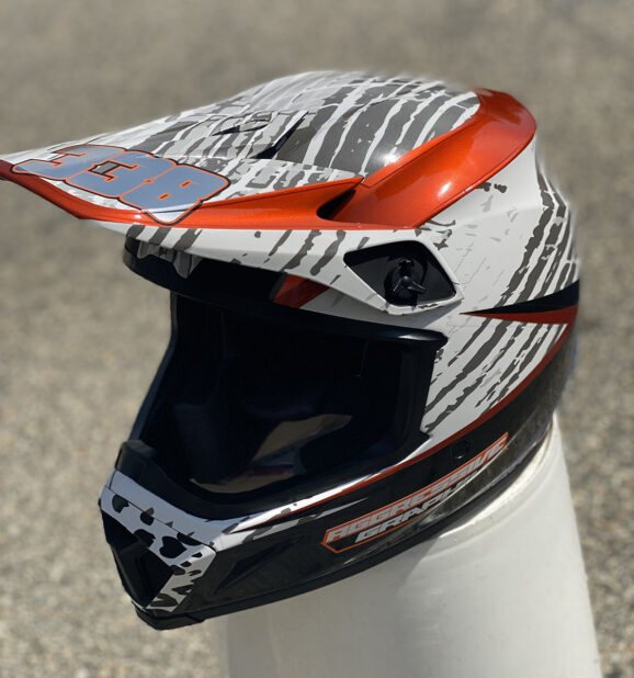 Custom motocross helmet wrap with metallic blue and orange